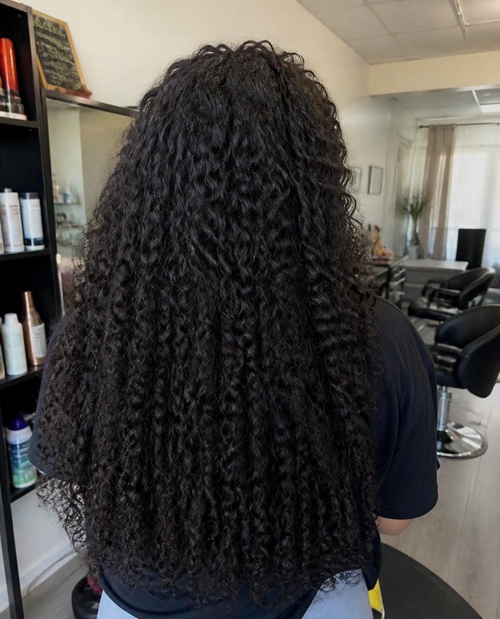 Lange lockige Haarverlängerung, Ansicht von hinten im Salon